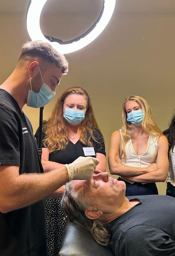 Interface Aesthetics mentorship session: a live-model patient, mentees and an expert trainer.